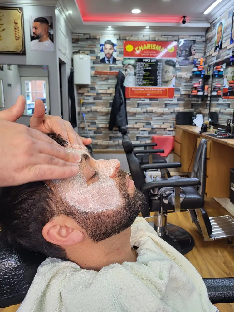Barber lathering shave cream by hand